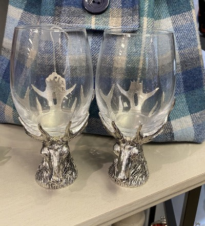 Wine glasses sitting on solid pewter stag base